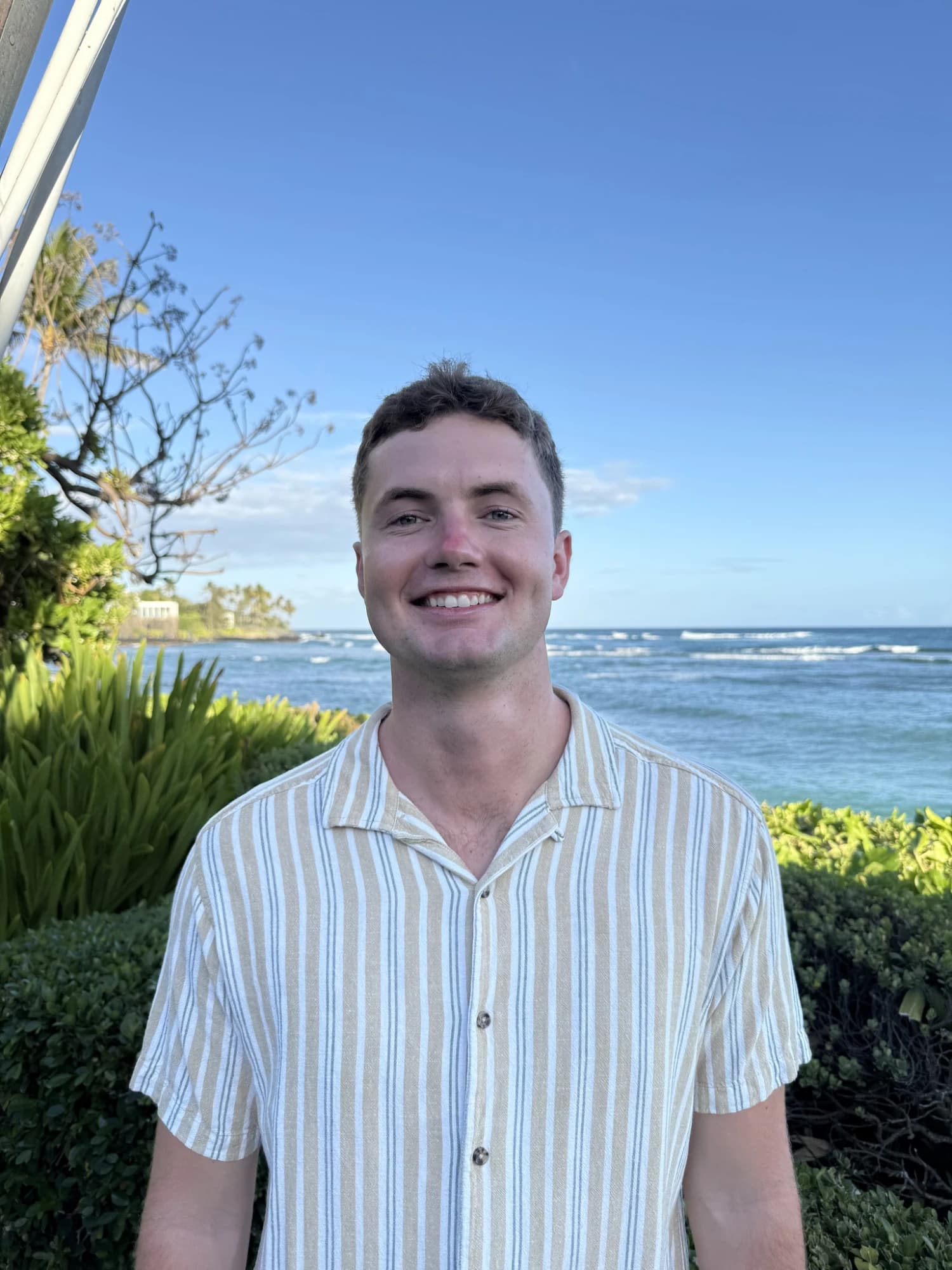 Ben McConnell, smiling, by the ocean