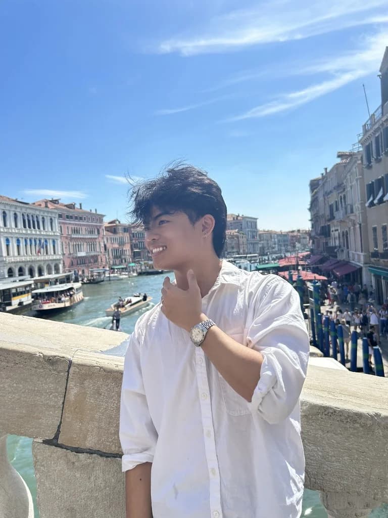 Samuel Chu, smiling, on a bridge over a canal